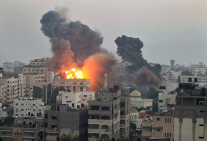 Smoke and fire from an Israeli bomb rises into the air ove Gaza City